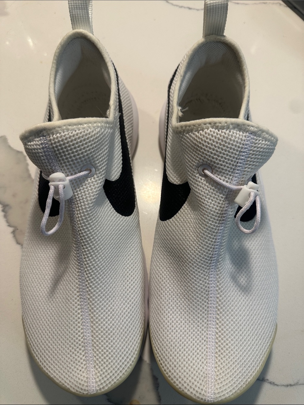 Nike Women's White Slip-On Sneakers with Black Swoosh